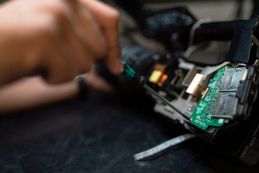 person repairing tech with a set of screwdrivers