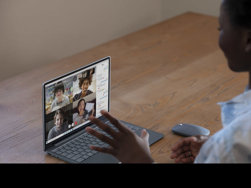 A person using the Microsoft Surface Laptop Go on a desk during a video call